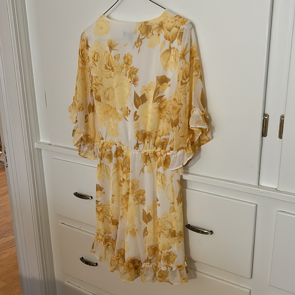 Express tie front yellow, gold floral romper with ruffle trim. Feminine.